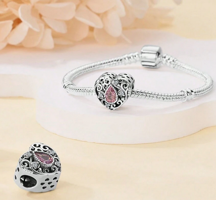 Elegant Pandora-Compatible Pink Heart Charm with Sparkling Cubic Zirconia on Sterling Silver Bracelet Background.